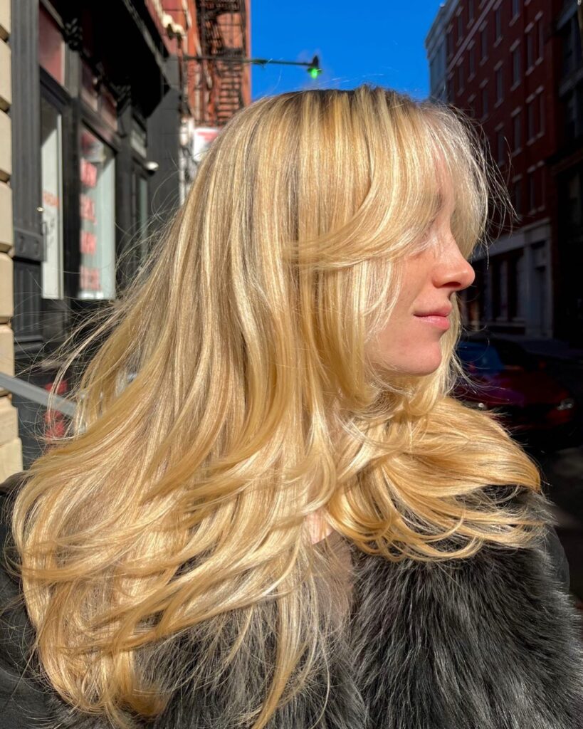 Golden Blonde Curtain Bangs With Sun Struck Layers