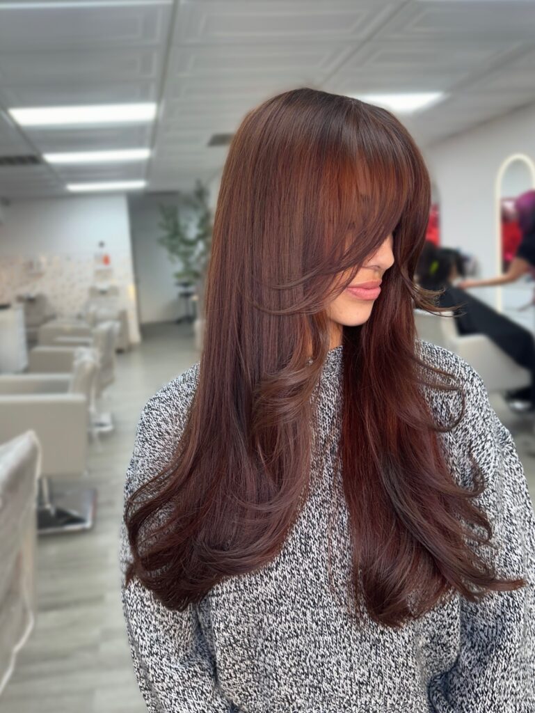 Rich Auburn Wispy Bangs With Cascading Layers