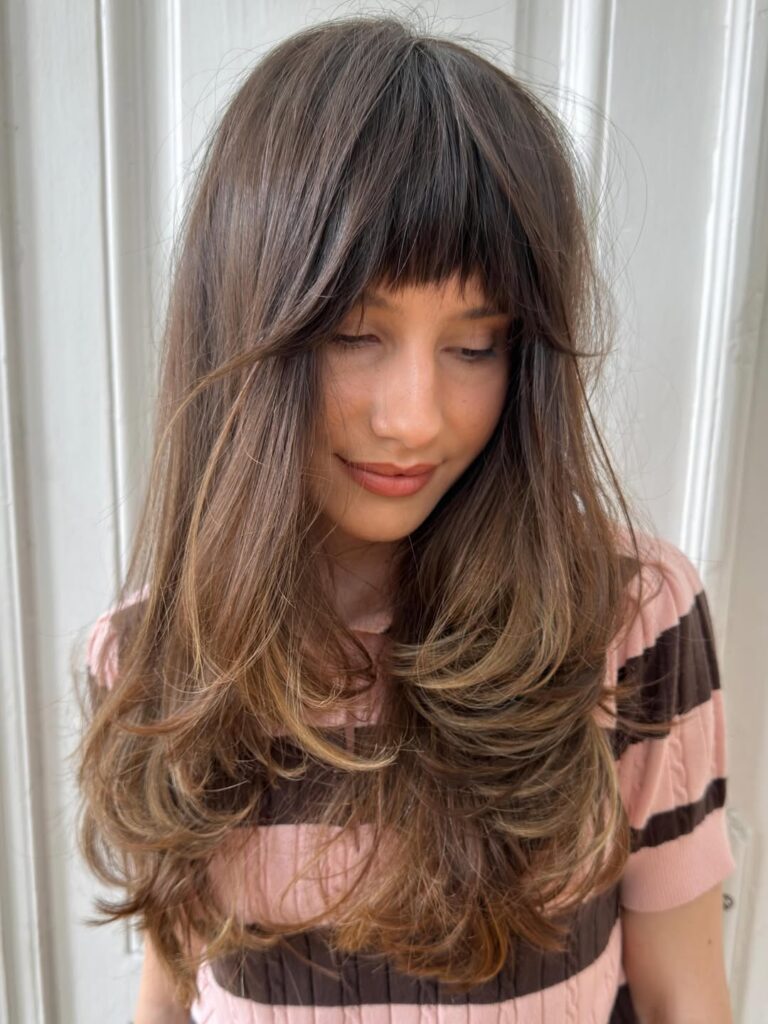 Blunt Fringe With Wispy Ends And Sun Kissed Layers